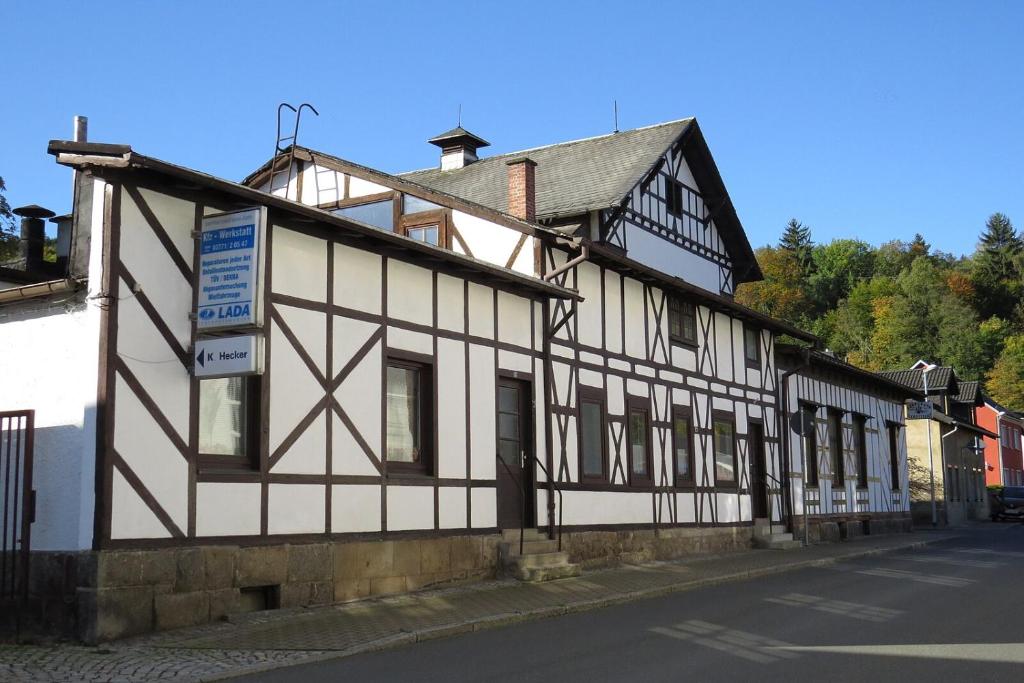 a black and white building on the side of a street at Schweizerhaus Aue in Aue-Bad Schlema