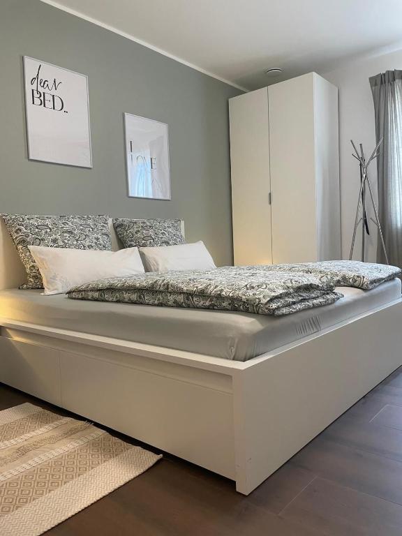 ein weißes Bett in einem Schlafzimmer mit einem weißen Schrank in der Unterkunft Casa Antonius in Lebach