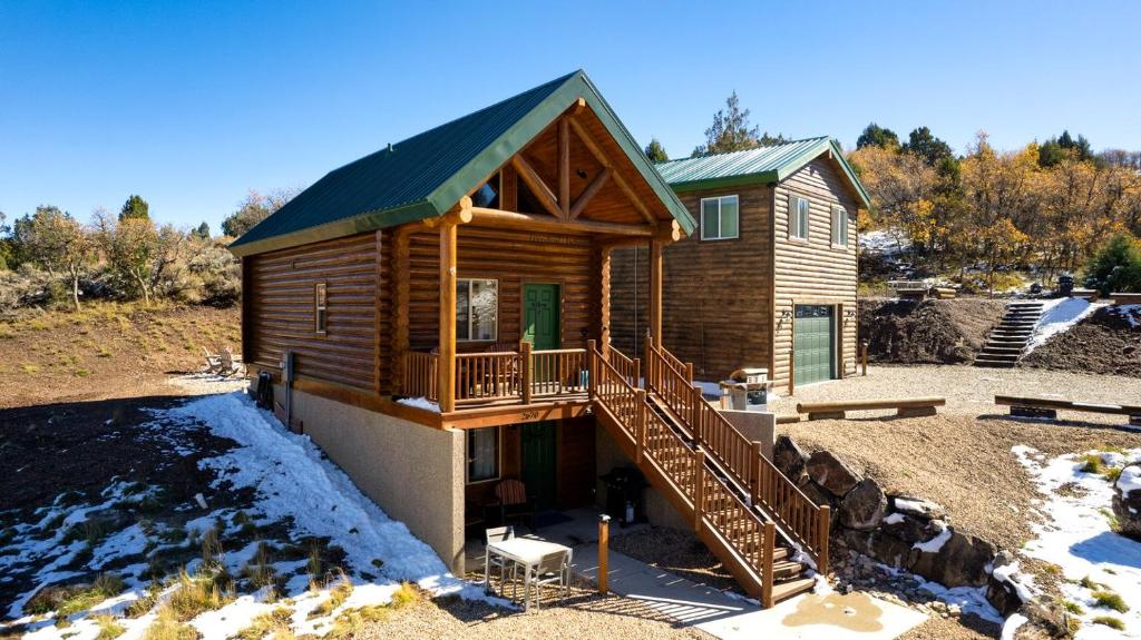 a log cabin with a porch and a deck at Stunning Cabin Rental for Glamping Escapes Between Bryce Canyon and Zion National Park in Long Valley Junction