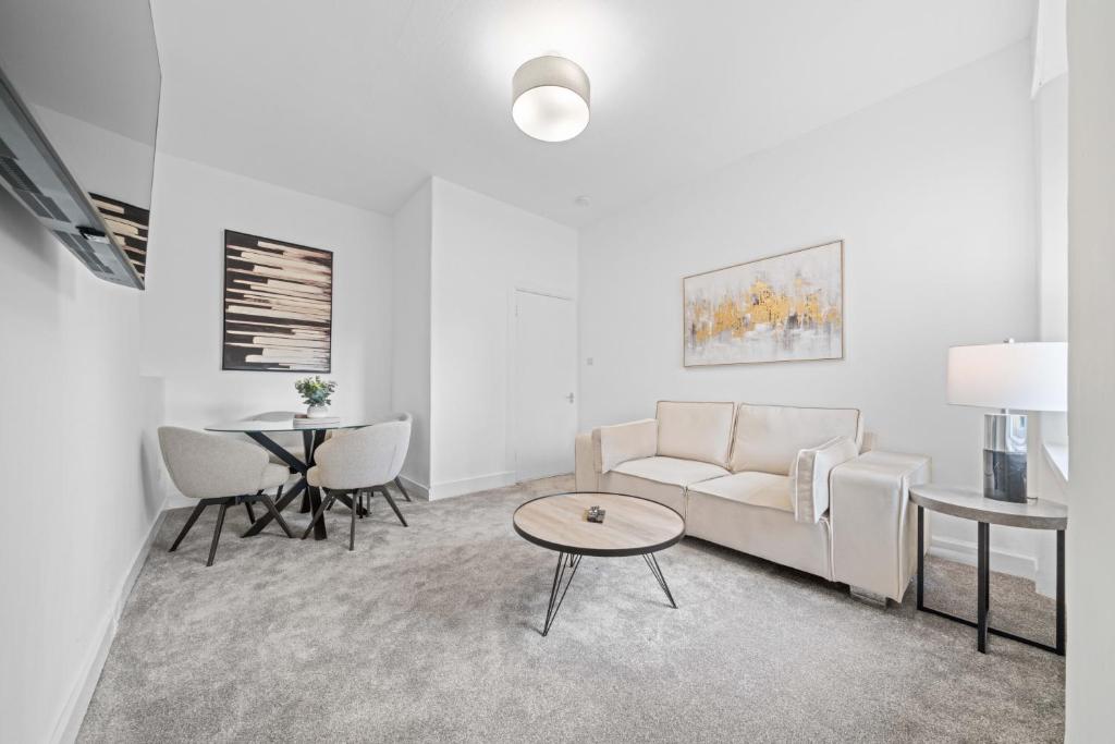 a living room with a couch and a table at Harbour Hideaway in Fife