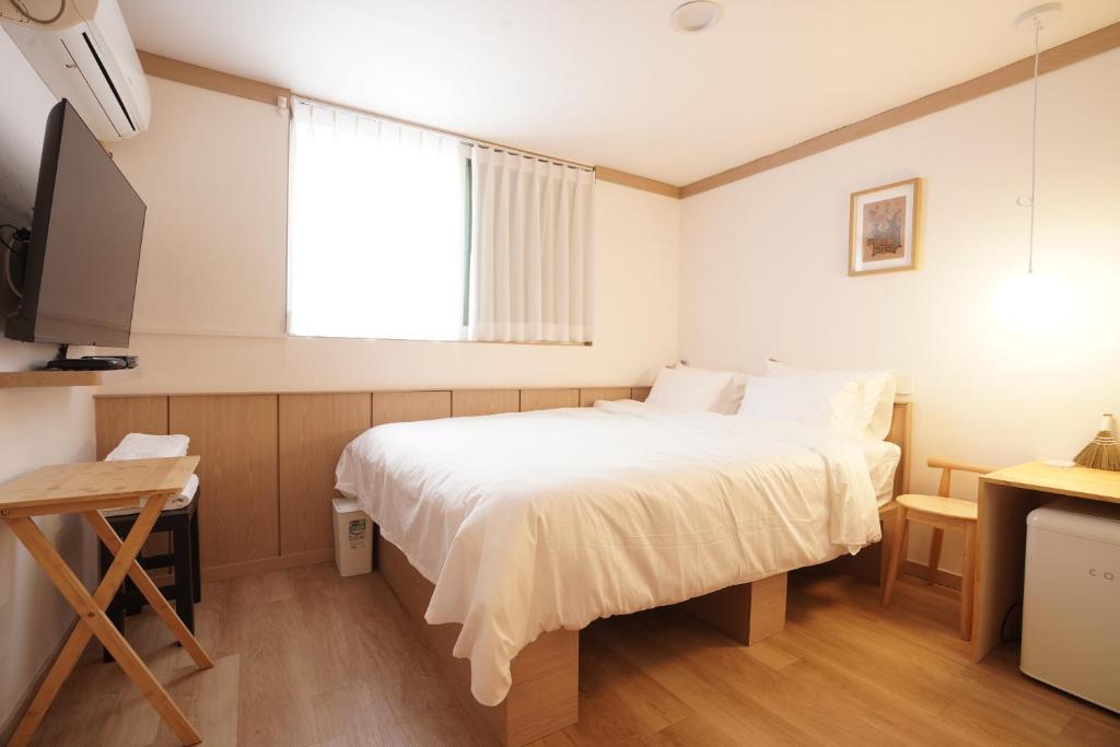 a small room with a bed and a television at stay105행궁 in Suwon