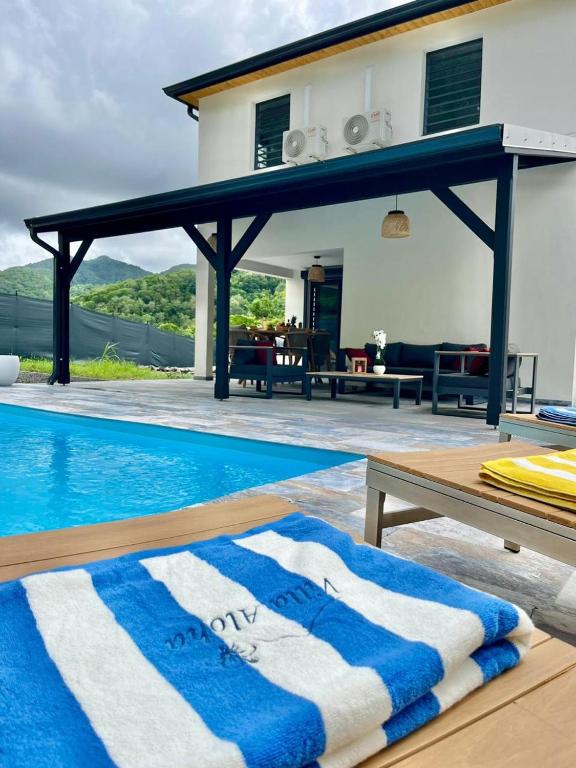 a villa with a swimming pool and a house at Villa Aloha - classée 5 étoiles - avec piscine in Les Trois-Îlets