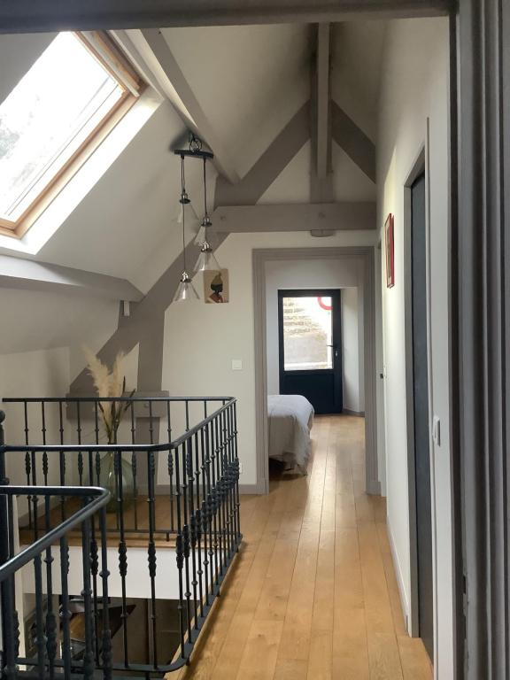 a hallway with a room with a bed and a window at Maison en pierre in Saint-Sozy