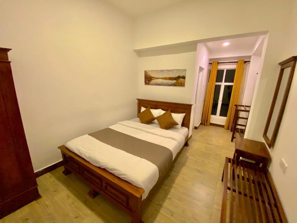 Ένα ή περισσότερα κρεβάτια σε δωμάτιο στο JETCO Lake Front Villa - Nuwara Eliya