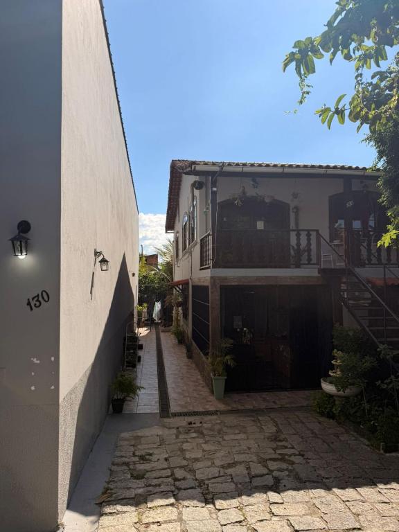 an alley with a house and a building at Pousada São José in Itatiaia