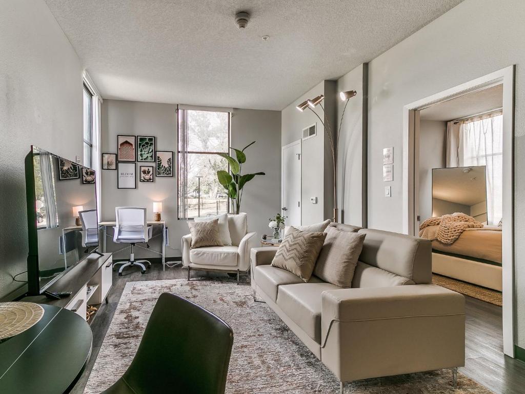 a living room with a couch and a bedroom at Boho, Walk East Village, Downtown, Free Parking in Des Moines