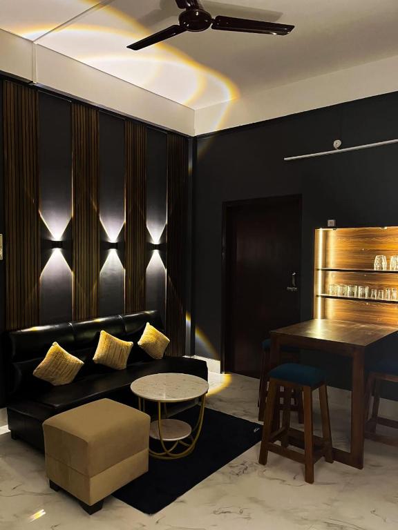 a living room with a couch and a table at Midtown Retreat in Dibrugarh