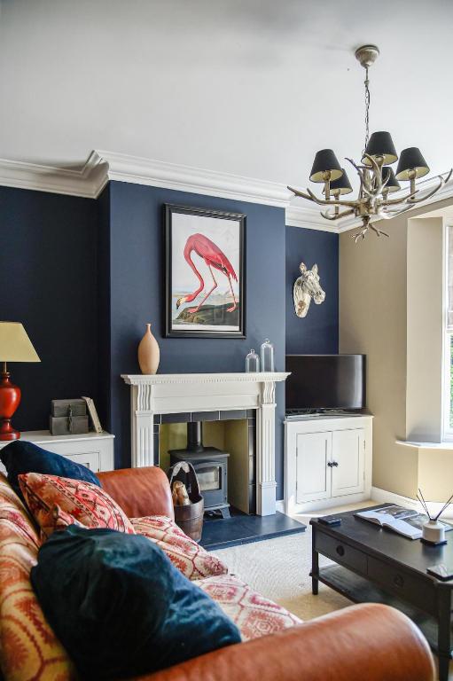 a living room with a couch and a fireplace at White Fox House in Burgess Hill