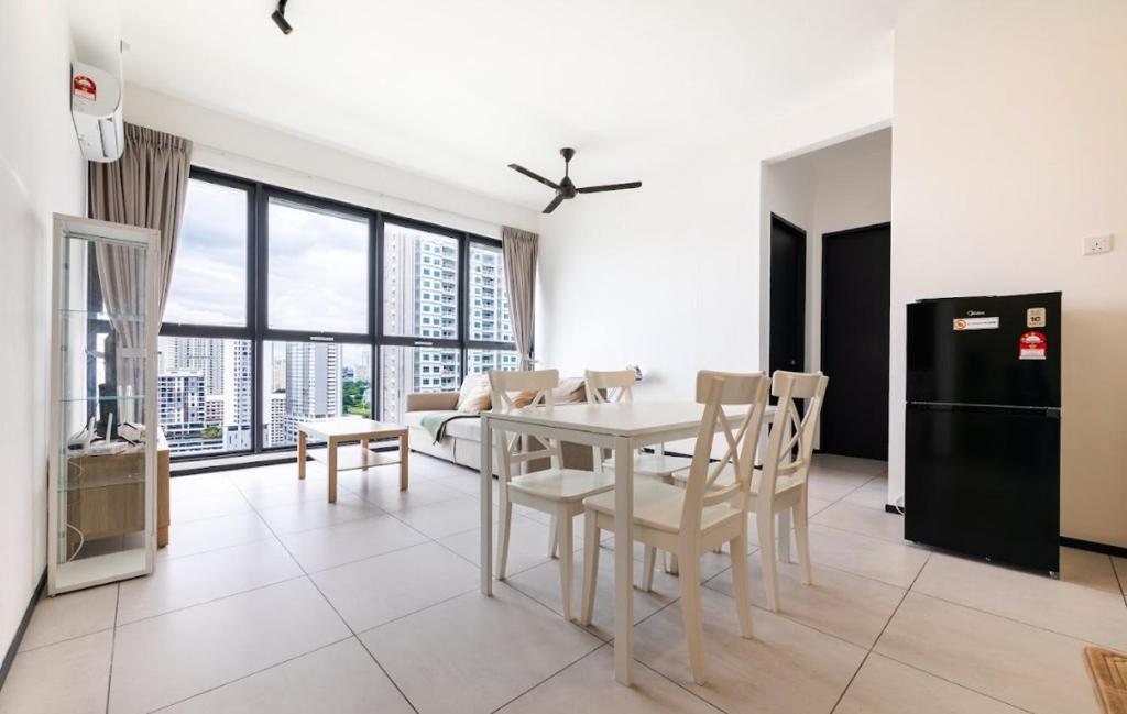 a kitchen and dining room with a table and chairs at Urban Suites Georgetown Penang - Affordable & Cozy Stay with High Floor-Sea & Penang Bridge View in George Town