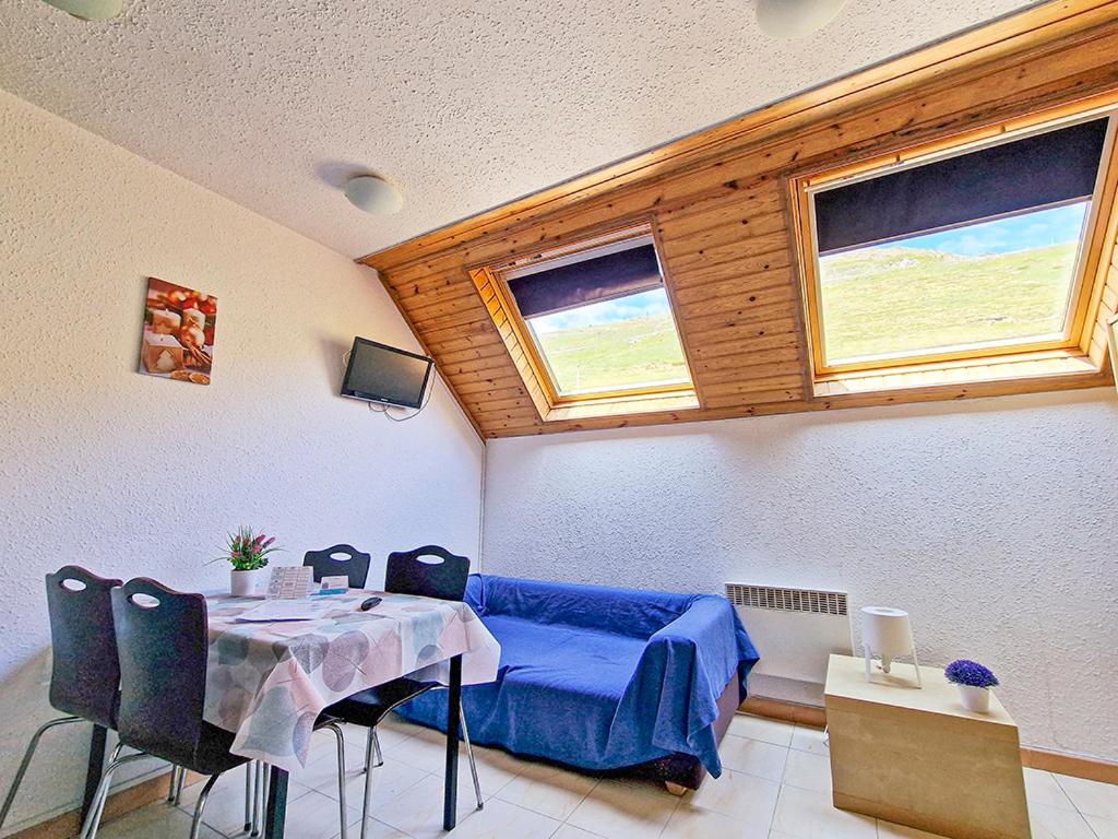 a living room with a table and a couch at Apartamentos Solaris 3000 in Pas de la Casa