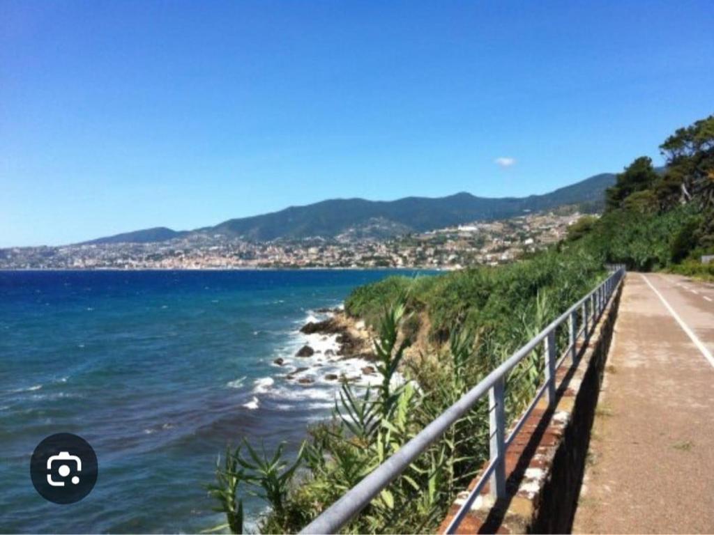 a view of the ocean from a path next to a beach at casa Mimi in Taggia