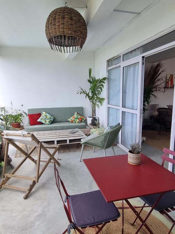 a living room with a couch and a table at Kazalea in Mt Bois Noir