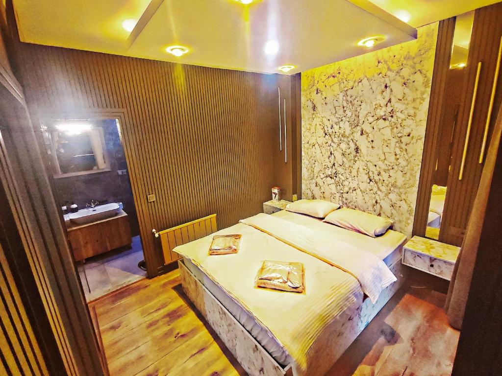 a bedroom with a large bed and a bathroom at Taksim Luxury Arcadia Hotel in Istanbul