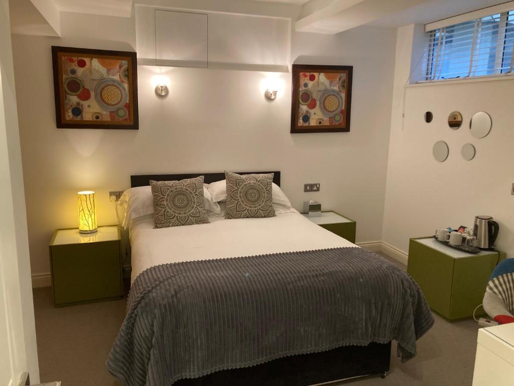 a bedroom with a large bed with two night stands at NELL GWYNN HOUSE - Hotel Room Style POD Room 61 in London