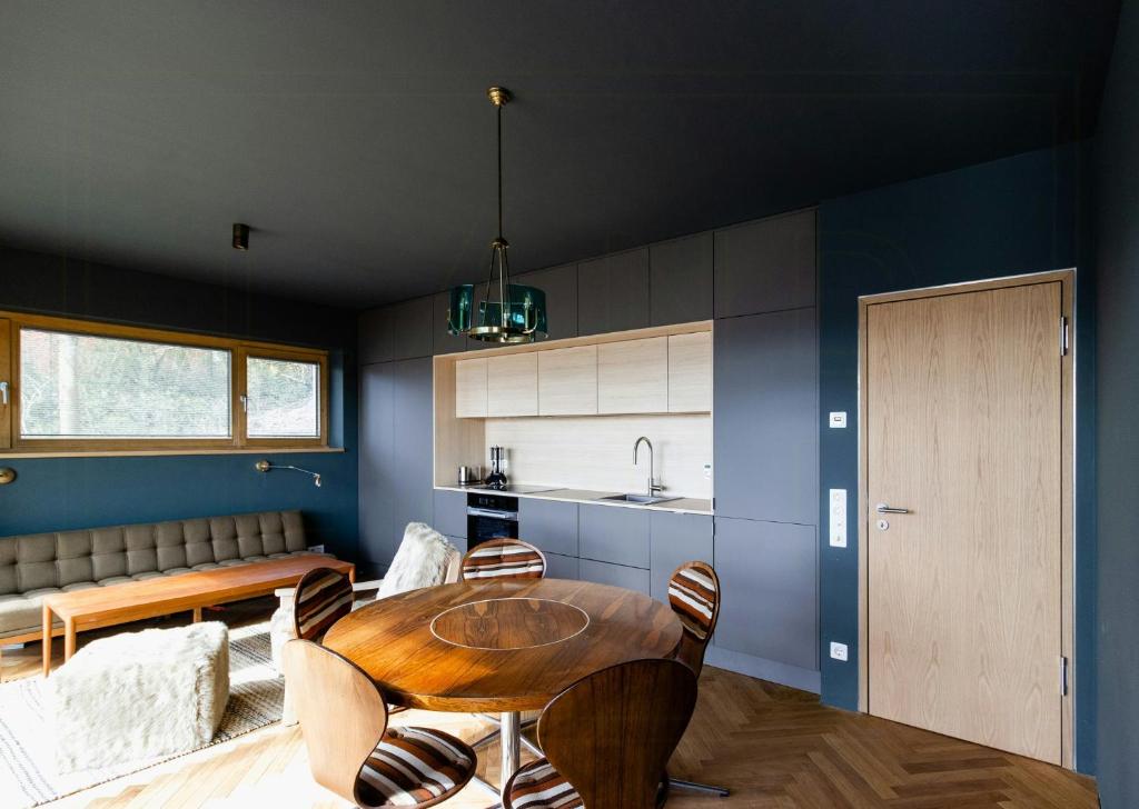 a kitchen and dining room with a table and chairs at Riverside Architect-Designed Garden Apartment in Süderstapel
