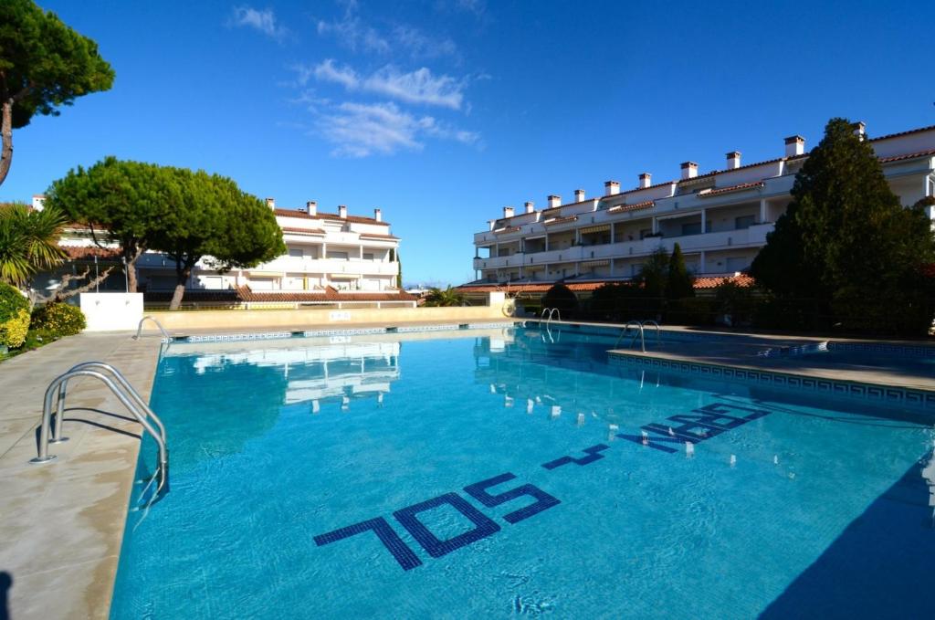 a large swimming pool in front of a building at Gran Sol C 01 in L'Escala