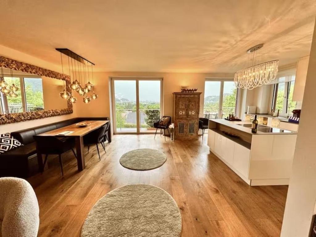 a kitchen and living room with a dining table and a counter at Traumhaus mit herrlichem Blick über Graz in Sankt Veit am Vogau