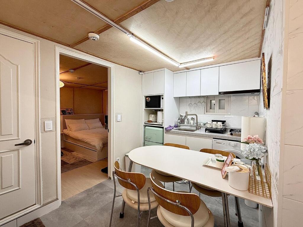 a kitchen with a table and chairs and a bedroom at Forest SB02 in Seoul