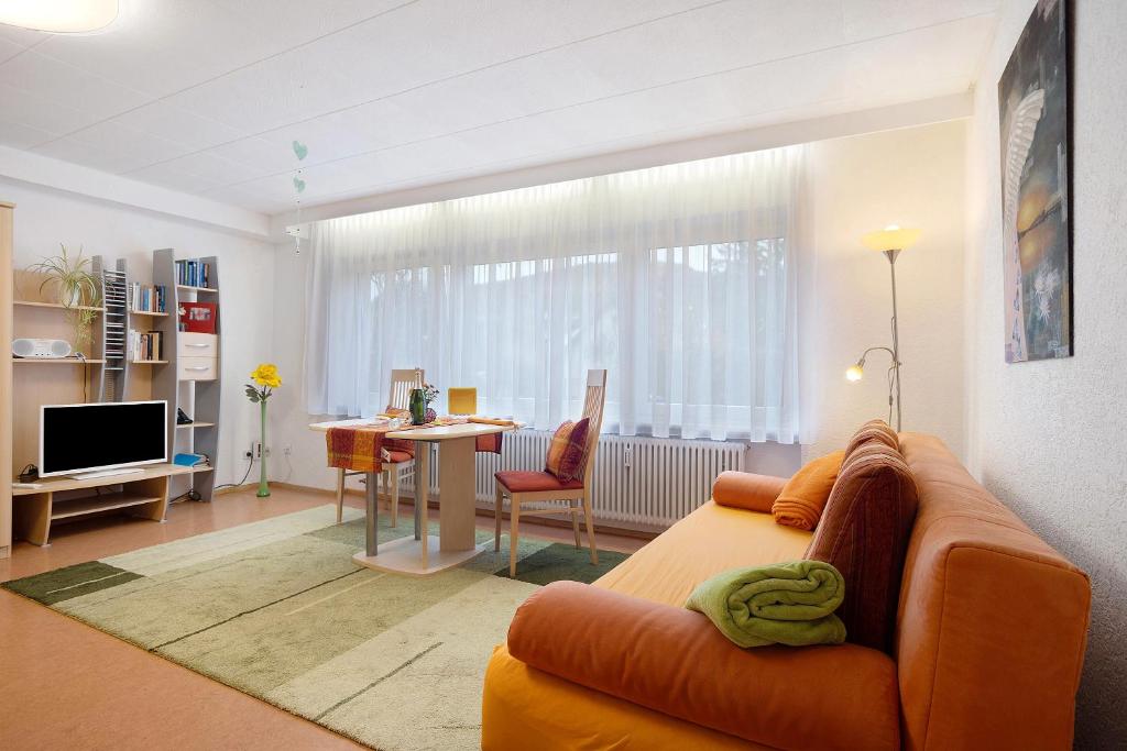 a living room with a couch and a table at Ferienwohnung Grünfelder in Au