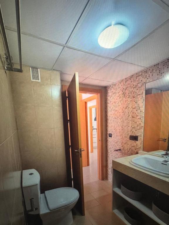 a bathroom with a toilet and a sink at Large terrace and views in Retamar