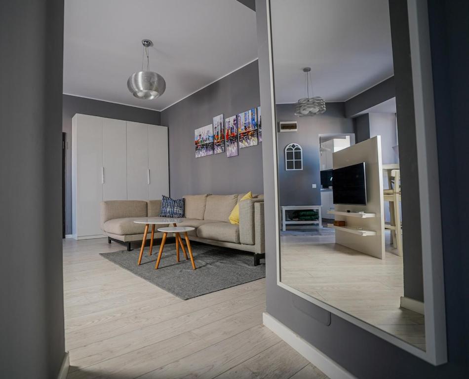 a living room with a couch and a table at Homey Apartment Obor in Bucharest