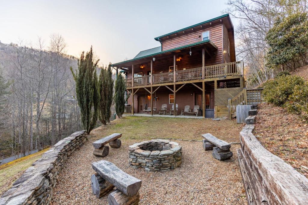 a house with a fire pit in front of it at Bear Creek in Sugar Grove