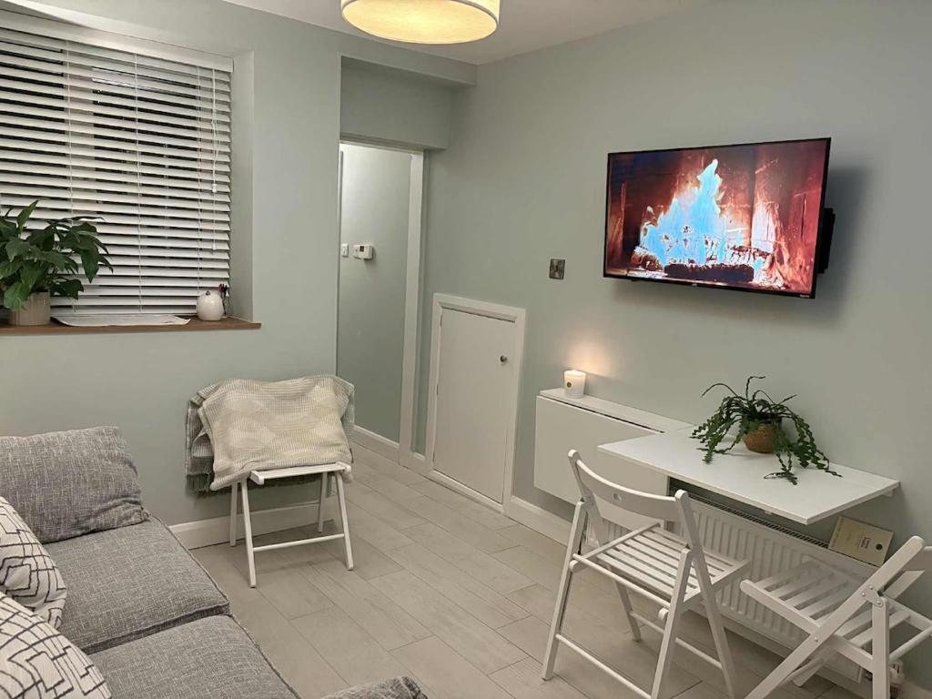 a living room with a couch and a table at Cosy Ground-Floor Flat in Omagh Centrally located in Omagh