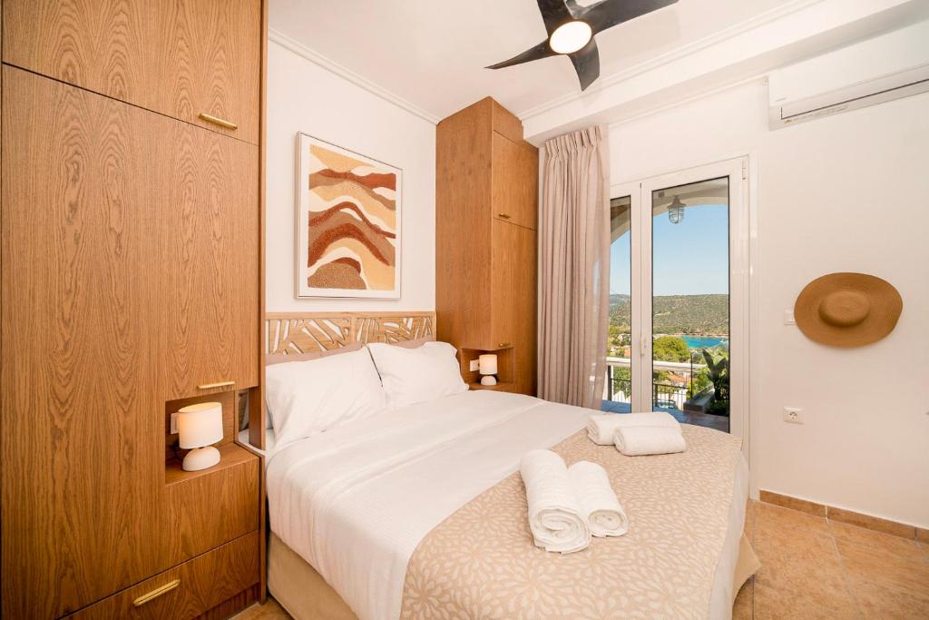 a hotel room with a bed and a window at Villa Calma by A&D Properties in Porto Rafti