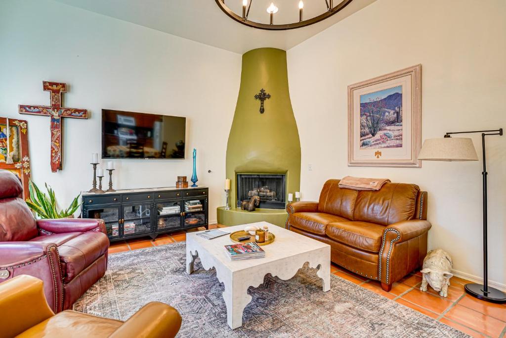 a living room with leather furniture and a cross on the wall at Sunny Adobe Retreat with Hot Tub and Mtn Views! in Tubac