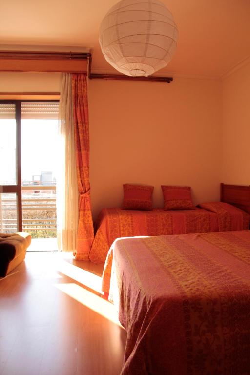 Postel nebo postele na pokoji v ubytování Residencial Dom Manuel