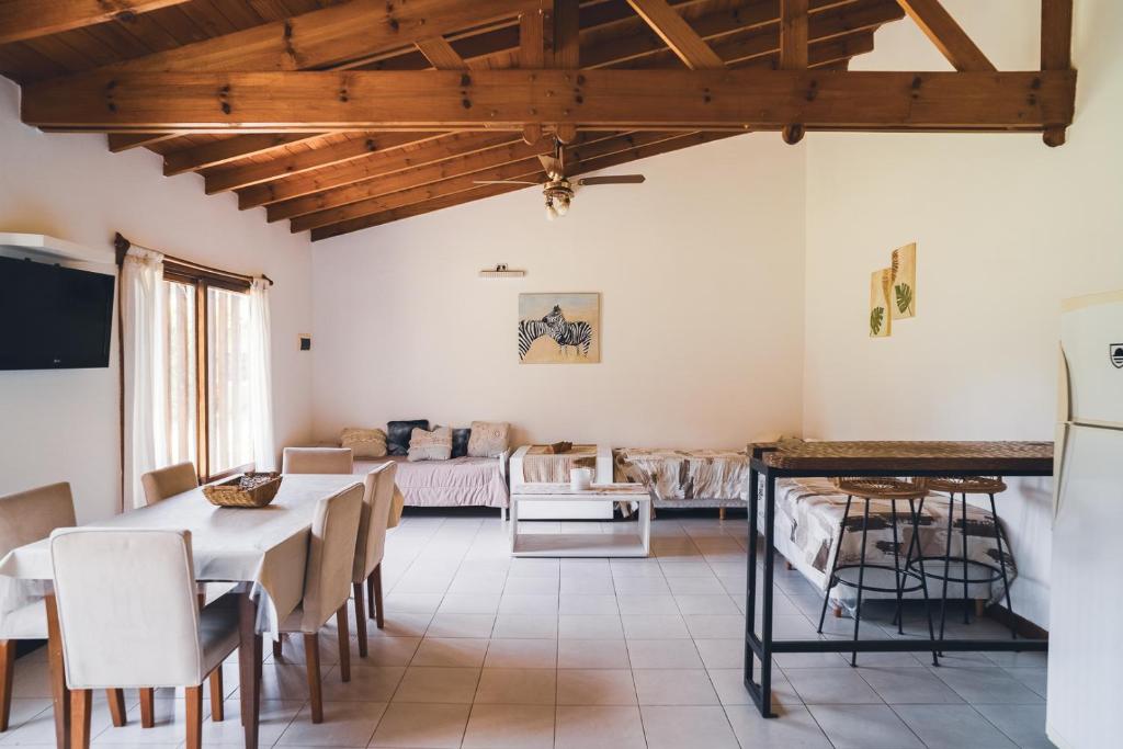 a kitchen and living room with a table and chairs at Check and Home - Chapa - 5 huéspedes con patio y parrilla in Chapadmalal