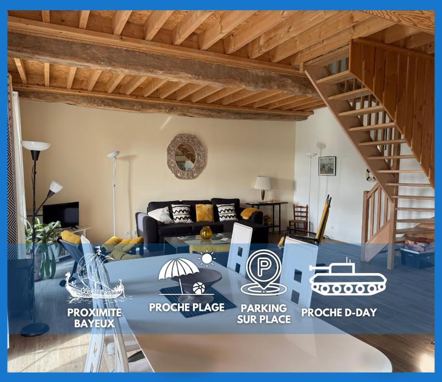 a living room with a blue table in a room at Nid de pie Grand duplex lumineux cadre verdoyant calme à 5 mn de la mer près Port en Bessin, Bayeux, Omaha Beach, in Commes