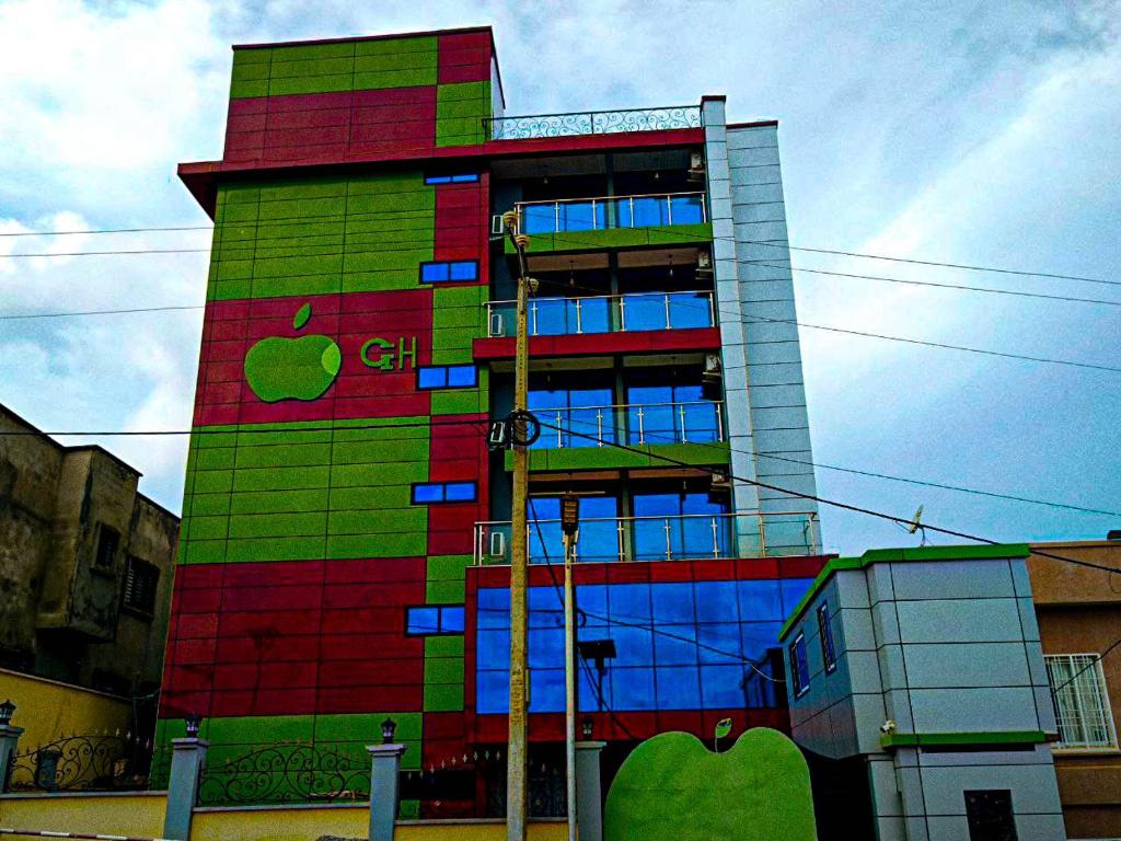 a multicolored building with an apple painted on it at Applegate Hotel in Yaoundé