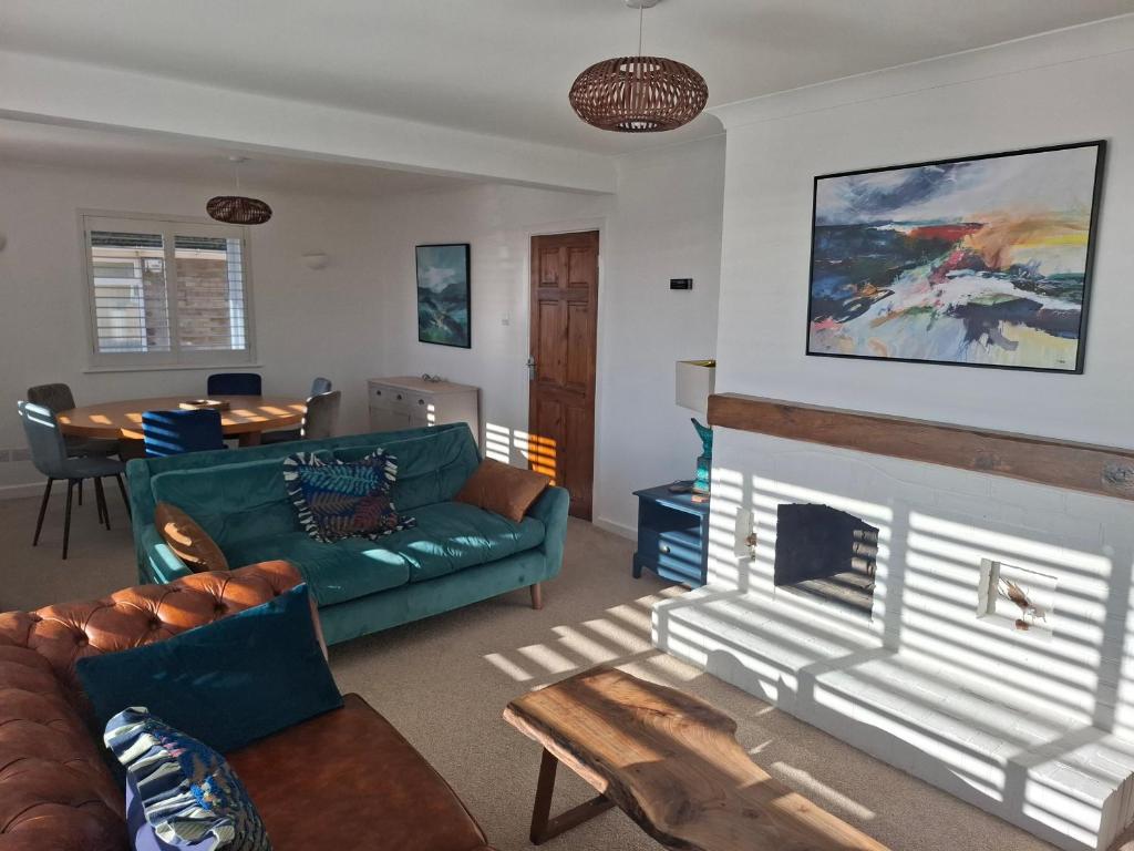 a living room with a couch and a fireplace at 4 Bedroom House in Saltdean, Brighton in Brighton & Hove