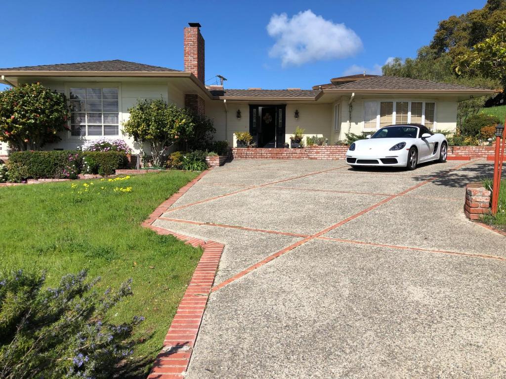 a white car parked in front of a house at Elegant suite-30 day minimum in Carmel