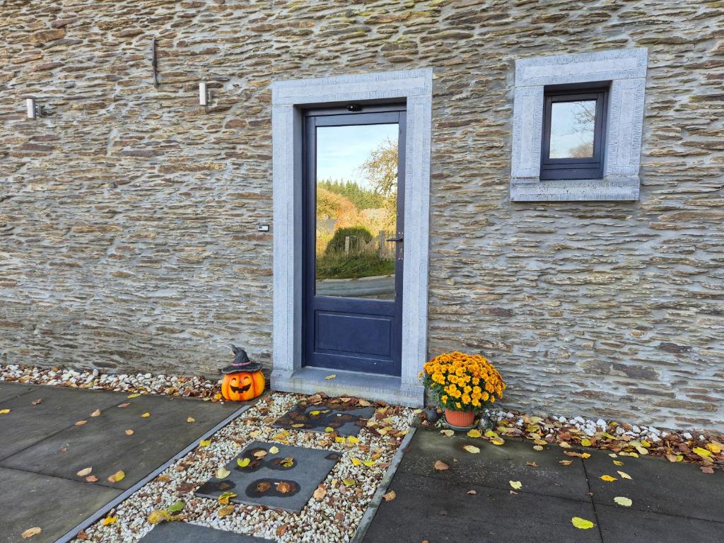 a house with a door and a pumpkin and a window at Villa Baboune in Bastogne
