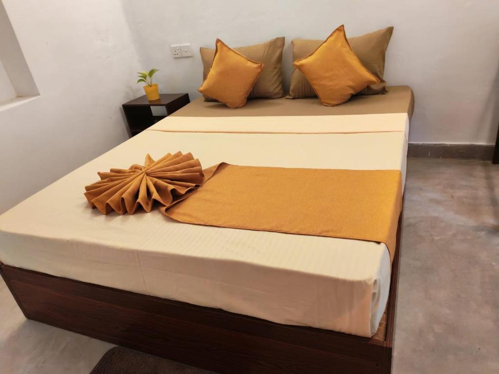 a bed with pillows on it in a room at Eco Bliss in Ahangama