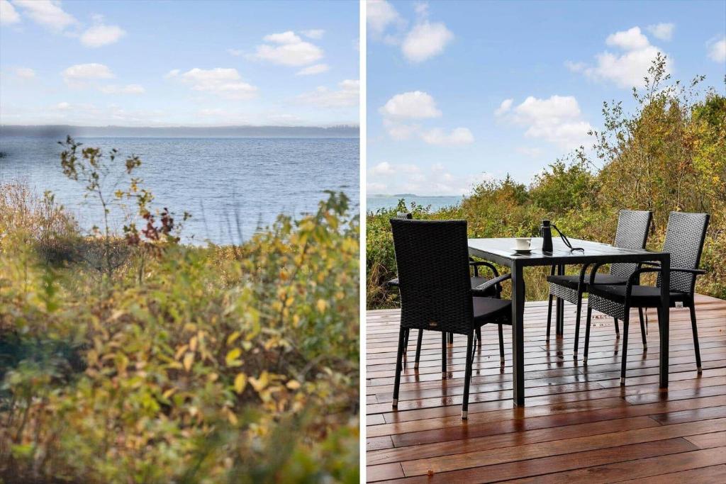 a table and chairs on a deck with a view of the water at LF18112-Veslos-Jegindovej-12 in Amtoft