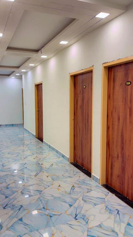 an empty room with a marble floor and doors at Maharaja hotel and dhaba in Roorkee