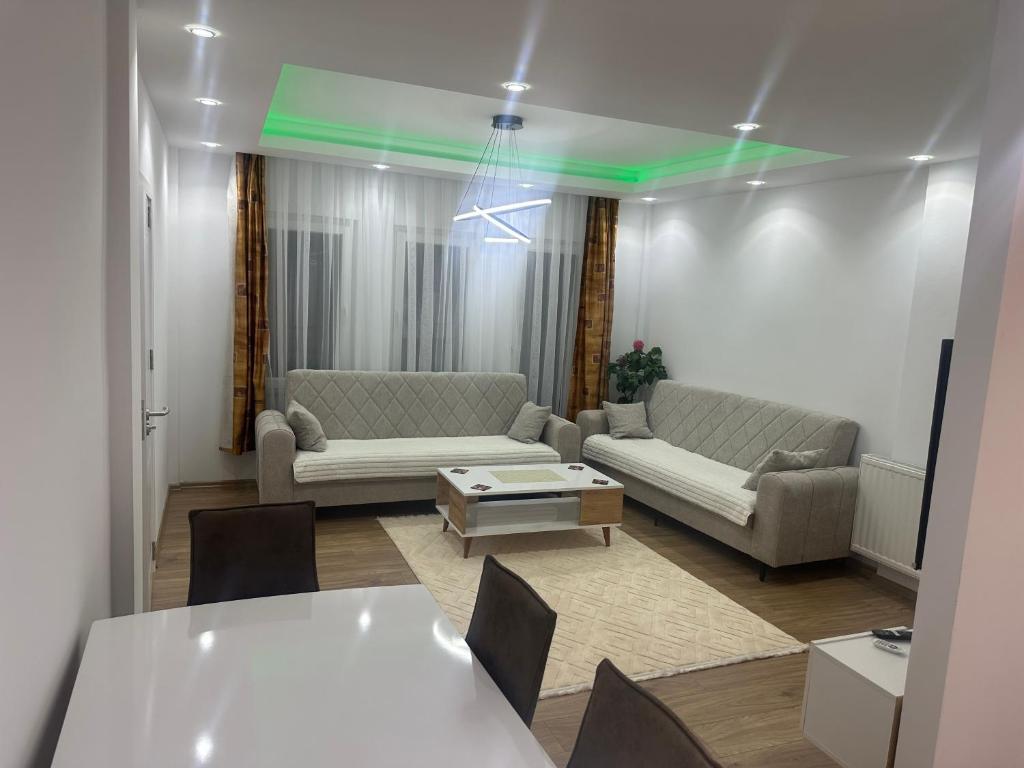 a living room with a couch and a table at Emir's Apartment in Pristina