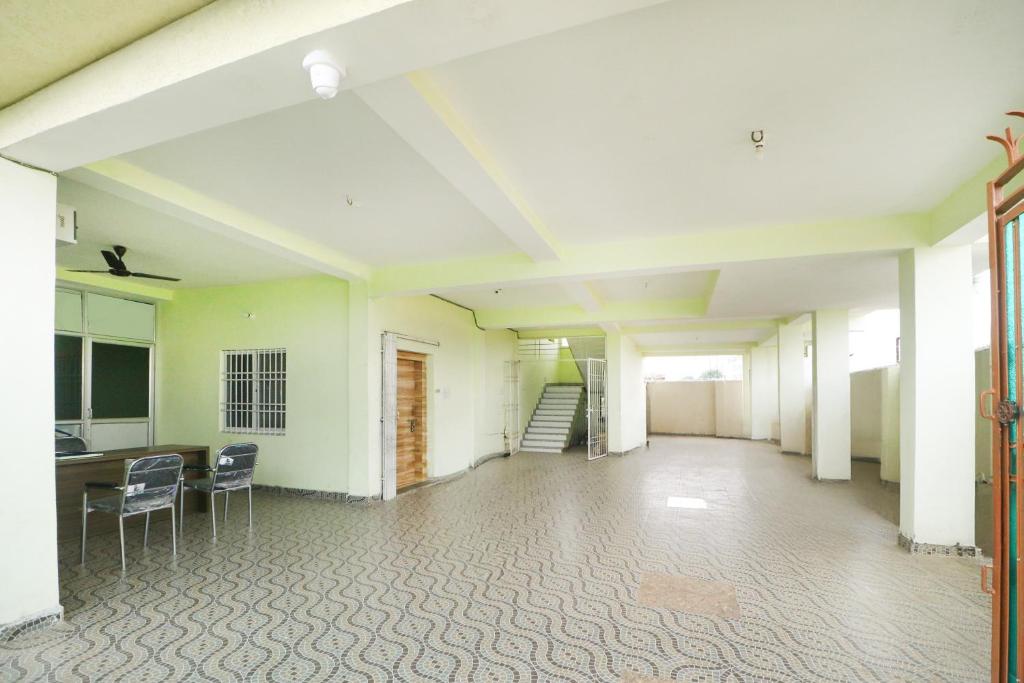 een lege kamer met stoelen en een trap in een gebouw bij Hotel O Royal Residency in Rānchī