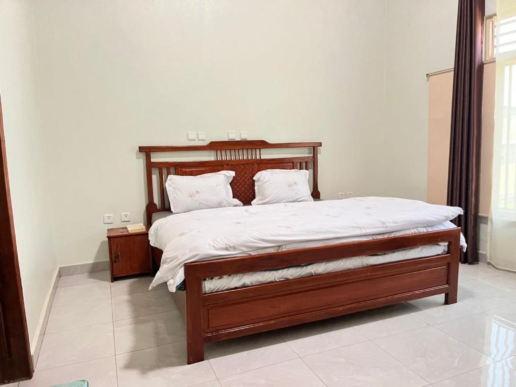 Ένα ή περισσότερα κρεβάτια σε δωμάτιο στο Kinigi Holiday Room