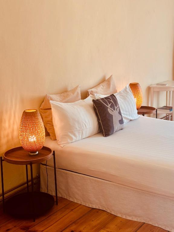 a bed with pillows and a lamp on it at Al Cavour 34 in Trento