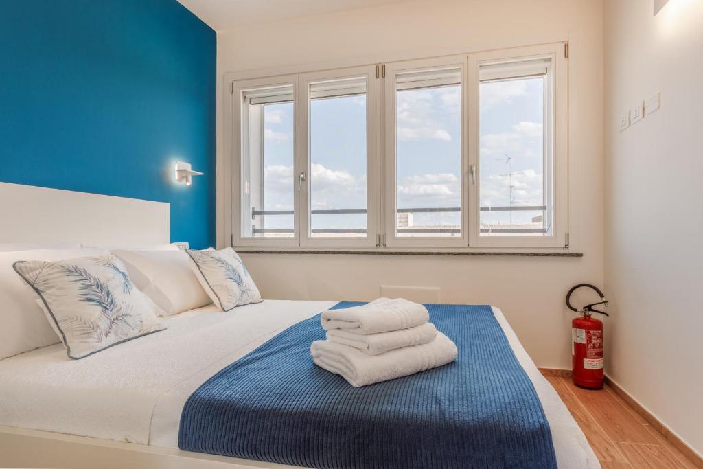 a bedroom with a bed with towels on it at Corso Adriano 13 - La Torre in Modena