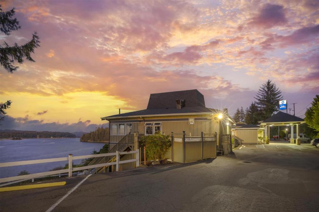 a building with a fence next to a body of water at Best Western Pier Point Inn in Florence