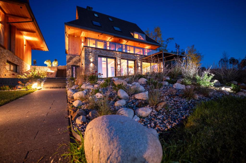 a house with a bunch of rocks in front of it at Janiołów Wierch 43 Jacuzzi i Sauna in Groń