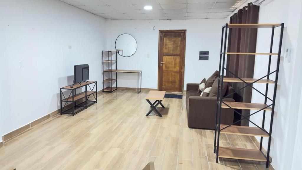 a living room with a couch and a mirror at Casa kuarahy in Asuncion