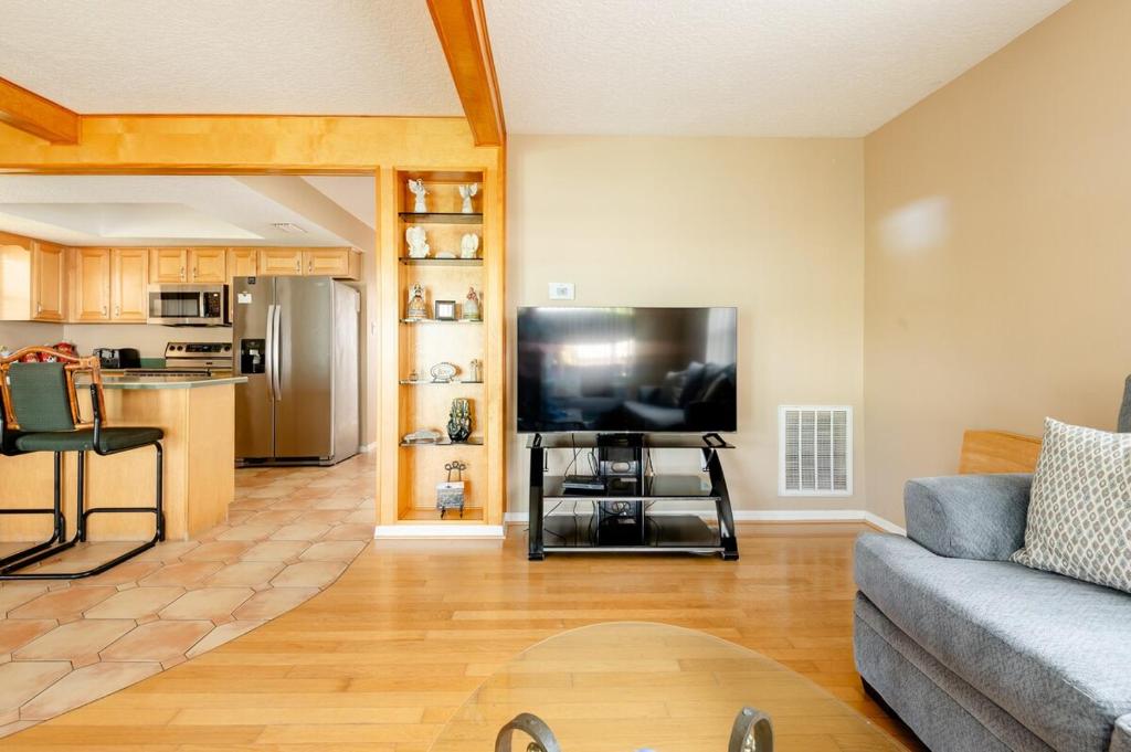 a living room with a couch and a large television at Welcome to Your Serene Waterfront Getaway! in Cocoa