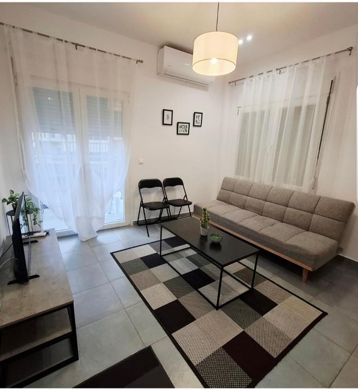a living room with a couch and a table at HomeBak Hospitality in Xanthi