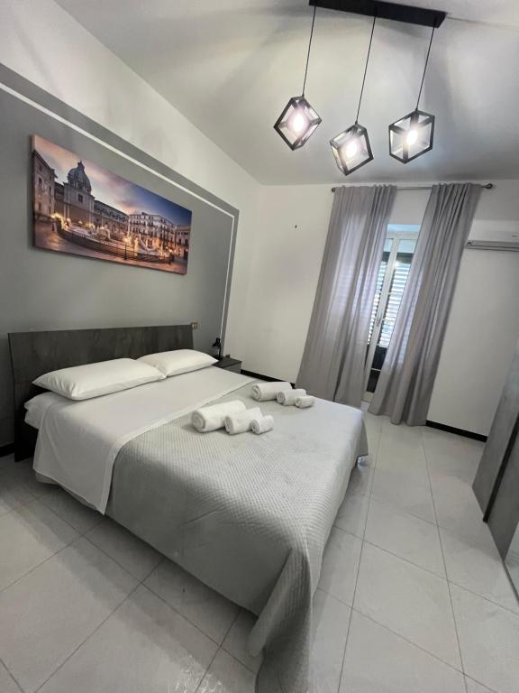 a bedroom with a large bed with towels on it at D'Aversa Rooms in Marineo